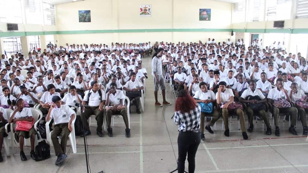 Students of Princes Town West Secondary listen intently to Ariel Wolffe's poem "Never Fall for your Type"