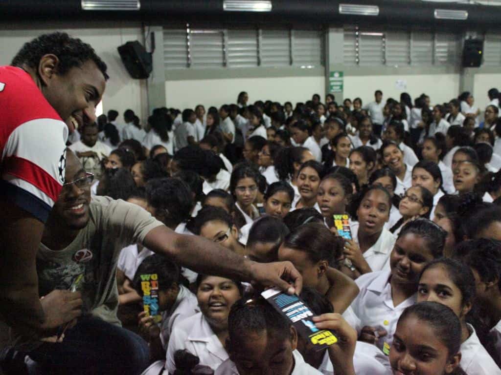 The 2 Cents team hand out Bocas Lit Fest bookmarks to eager students of Naparima Girl's High School