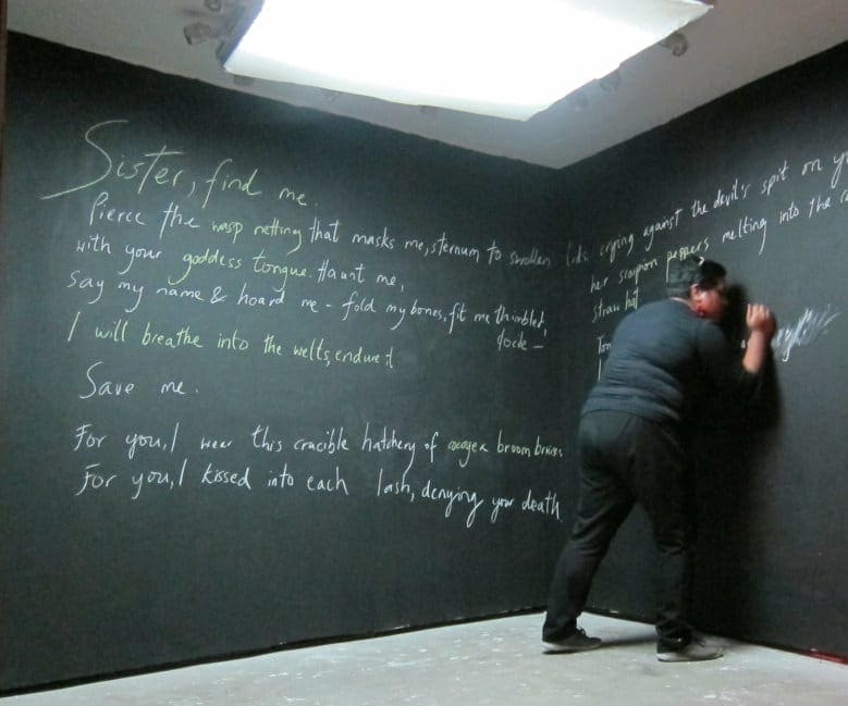 I write one of my poems onto the walls.