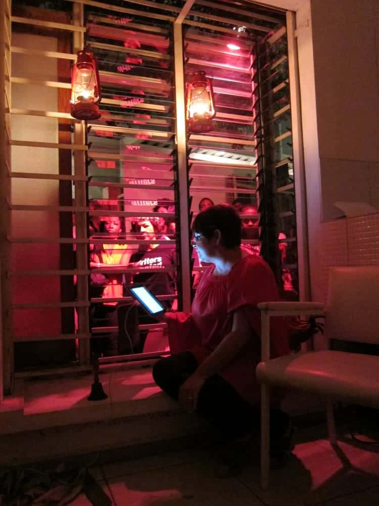 Sharon Millar reads "The Gayelle" to her audience through a lantern-lit window.
