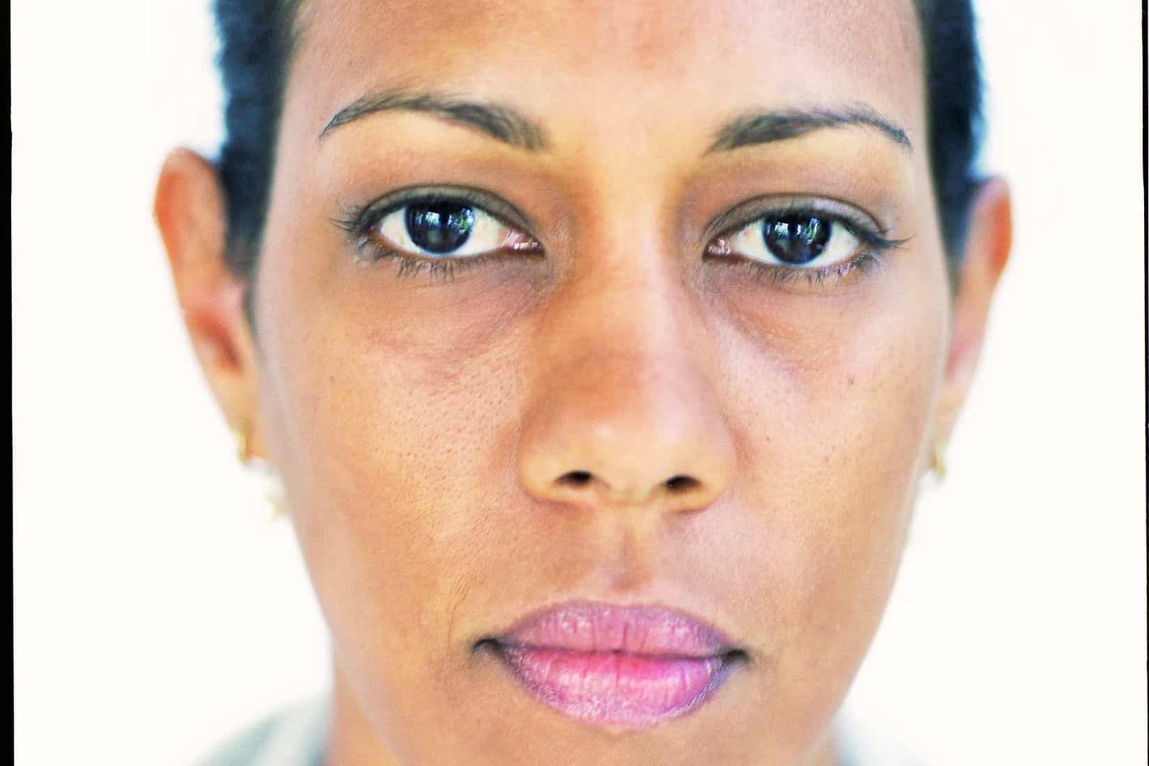 Close-up portrait of contemporary artist Kwynn Johnson looking directly at the camera.