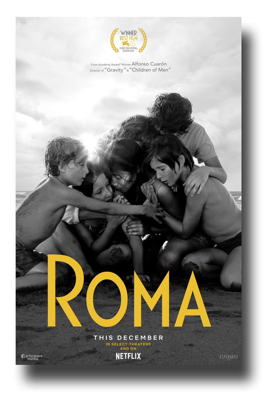 Film poster for the film “ROMA,” showing a group of children huddled together on a beach in black and white.